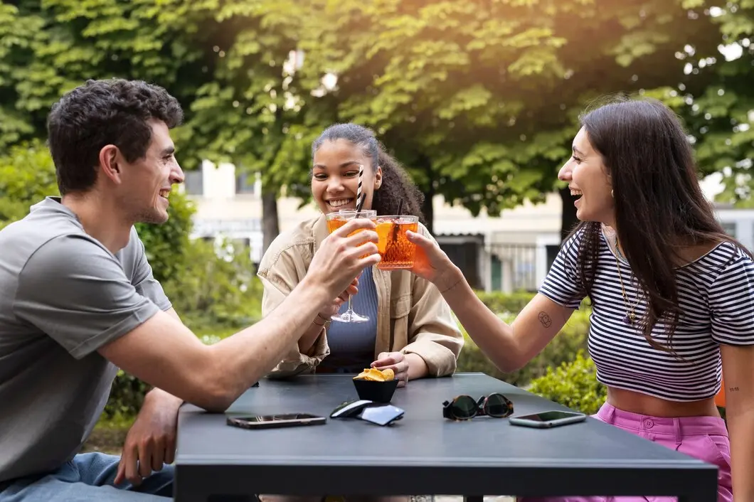 A group of friends socializing and laughing together in a cheerful setting.